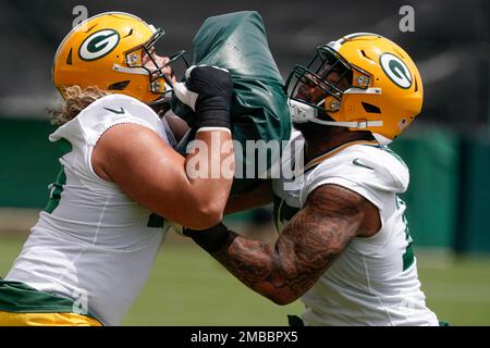 Green Bay Packers' Sean Rhyan and George Moore run a drill at the NFL  football team's practice field training camp Tuesday, May 31, 2022, in Green  Bay, Wis. (AP Photo/Morry Gash Stock