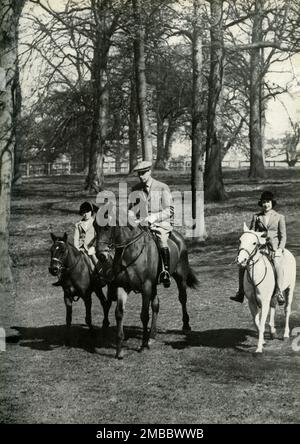 'Birthday Ride - 21st April, 1939', 1947. King George VI horse-riding with daughters Princess Margaret Rose, and Princess Elizabeth (future Queen Elizabeth II) on her birthday. From &quot;Princess Elizabeth: The Illustrated Story of Twenty-one Years in the Life of the Heir Presumptive&quot;, by Dermot Morrah. [Odhams Press Limited, London, 1947] Stock Photo
