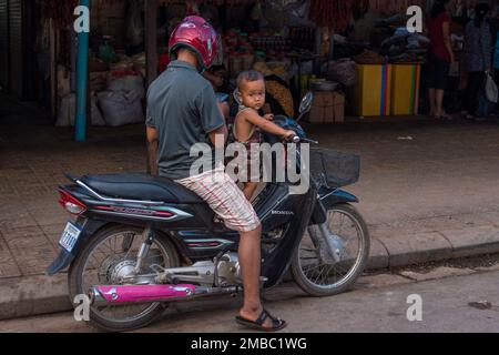 Father and son riding a Moped in asia vietnam. Stock Photo