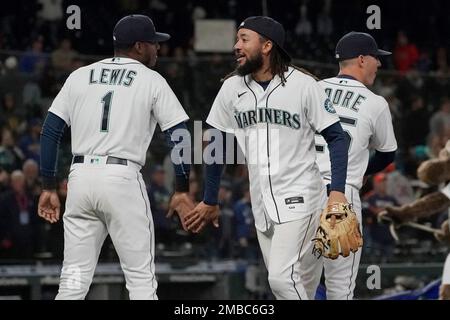 Seattle Mariners' Kyle Lewis, left, is greeted by Taylor Trammell