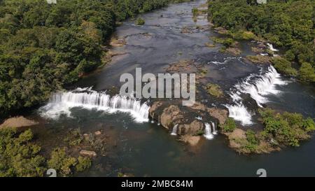 An aerial view of waterfalls in the Koh Kong province near the eco-community of Chi Phat, in Cambodia, surrounded by green forest, on a sunny day Stock Photo