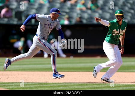 Oakland, USA. 26th May, 2022. Texas Rangers left fielder Brad Miller (13)  swings at a pitch during the second inning against the Oakland Athletics in  Oakland, CA Thursday May 26, 2022. (Image