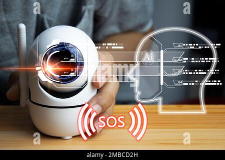 The concept of using IP cameras for security,White ip camera lies on wooden floor, man using ip camera Stock Photo