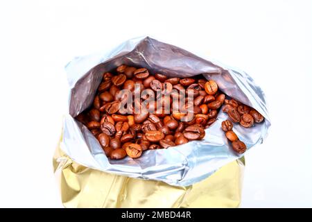 Foil fresh bag full of espresso roasted coffee beans isolated on a white background Stock Photo