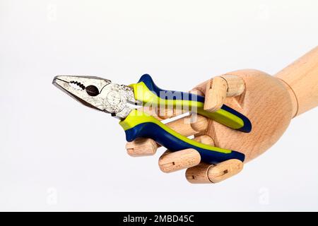 Wooden hand holding pliers hand tool isolated on a white background Stock Photo