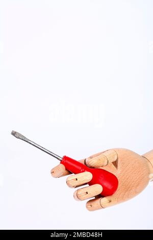 Wooden hand holding a slotted blade screwdriver isolated on a white background Stock Photo