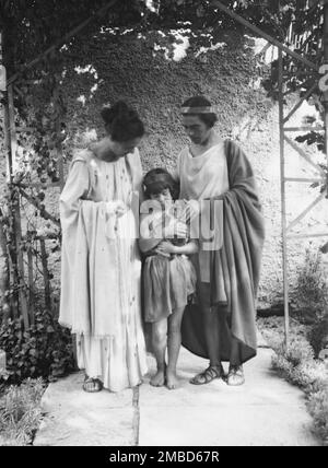 Kanellos, Vanellos and Tanagra, and child holding a cat, in dance costumes, 1929. Stock Photo