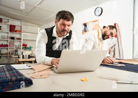 Two colleagues working together in sewing workshop Stock Photo