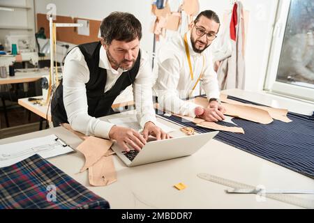 Team of tailors working together in atelier Stock Photo