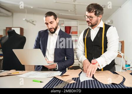Fashion designers working on male clothing collection Stock Photo