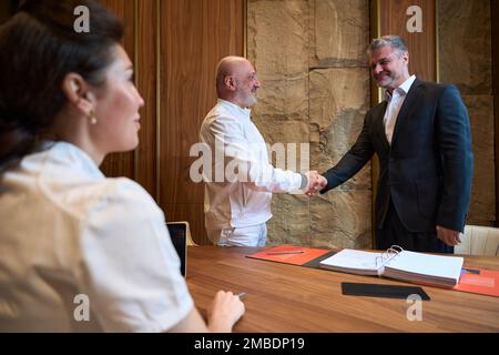 Handshake between a doctor and a patient in an office Stock Photo