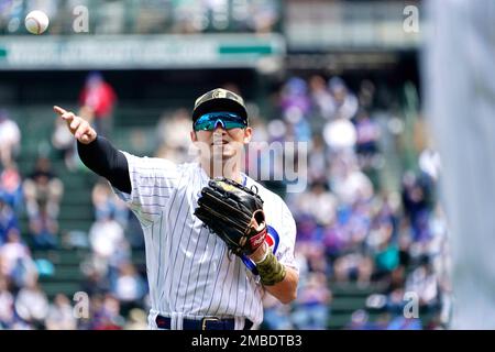 Chicago Cubs' Seiya Suzuki, of Japan, adjusts his hat as he pauses in the  dugout prior to a baseball game against the Arizona Diamondbacks Sunday,  May 15, 2022, in Phoenix. (AP Photo/Ross