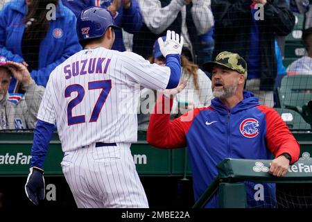 The Chicago Cubs' Seiya Suzuki (R) is congratulated by first base coach  Mike Napoli after hitting an RBI single in the fourth inning of a baseball  game against the Pittsburgh Pirates on