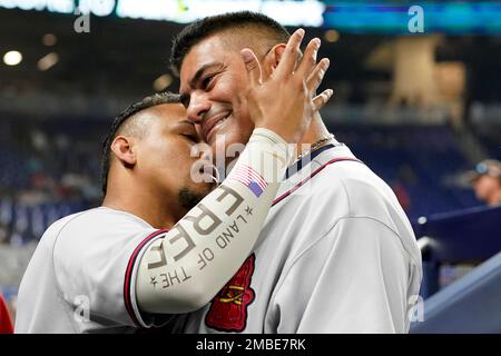 Atlanta Braves' Ozzie Albies, left, and Orlando Arcia (11) joke around in  the dugout in the seventh inning against the Detroit Tigers during the  first baseball game of a doubleheader, Wednesday, June