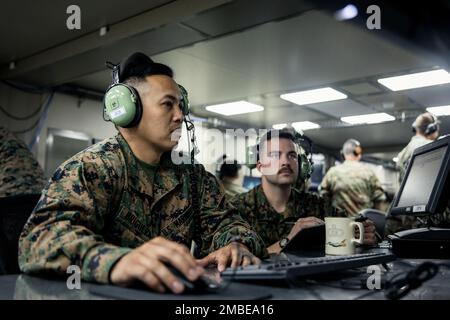 U.S. Marine Corps Cpl. Adonis Briguera, left, an operator controller with Marine Aircraft Control Group 48 (MACG-48), 4th Marine Aircraft Wing, Marine Forces Reserve, from Virginia Beach, receives instruction from Staff Sgt. Trevor Roberts, a tactical air traffic controller with MACG-48, 4th Marine Aircraft Wing, Marine Forces Reserve, from Welchs, Virginia, during a joint live flight exercise at McConnell Air Force Base, Kansas, June 15, 2022. Exercise Gunslinger 22 is a joint exercise with the Kansas Air National Guard and U.S. Marine Corps designed to increase aircraft control and training Stock Photo