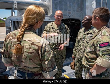 VIRGINIA BEACH, Va. (June 15, 2022) Master Chief Operations Specialist Josh Pearsall, assigned to Assault Craft Unit 4, briefs Royal Marines Commando Warrant Officer 1st Class Mick Stanion, NATO's Allied Maritime Command (MARCOM) senior enlisted leader, and Royal Air Force Warrant Officer Sara Catterall, NATO's Allied Air Command (AIRCOM) senior enlisted leader, during a visit to Assault Craft Unit 4, June 15. Stanion and Catterall, the two senior enlisted leaders for MARCOM and AIRCOM, the commands that run NATO operations in the maritime and air domains, visited the Hampton Roads area to lea Stock Photo