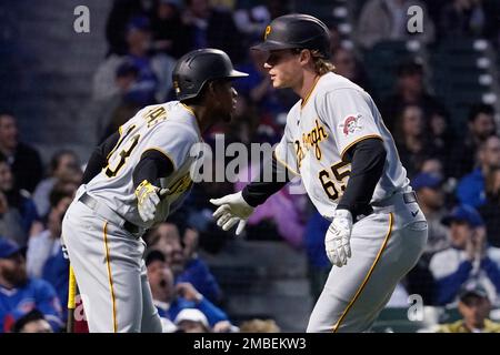 Pittsburgh Pirates' Jack Suwinski, right, is greeted in the dugout