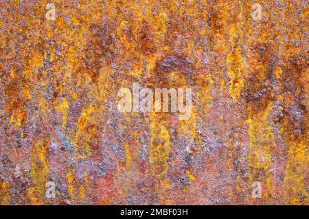 Metal panel has developed rust in vibrant orange, yellow and brown colors Stock Photo