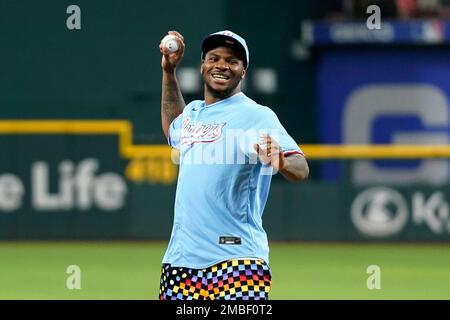 Dallas Cowboys player Micah Parsons walks to the mound to throw out the  ceremonial first pitch before a baseball game between the Los Angeles  Angels and the Texas Rangers, Tuesday, May 17