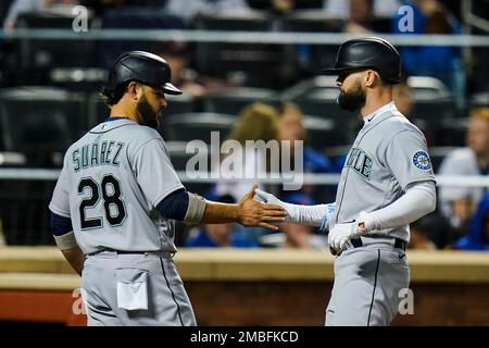 Seattle Mariners' Eugenio Suarez holds a trident as he celebrates