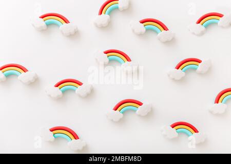 Rainbow erasers with smiling clouds on white background, top view Stock Photo