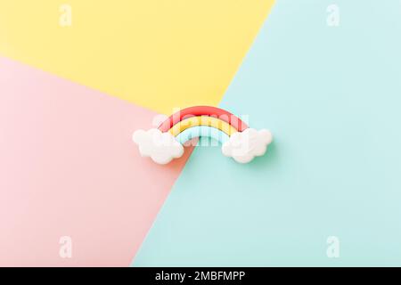 Rainbow erasers with smiling clouds on color background, top view Stock Photo