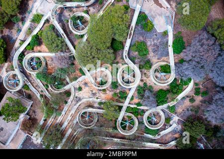 Aerial view of an abandoned old gloomy water park due to bankruptcy. Taken from a drone sunny day. Abstract Stock Photo