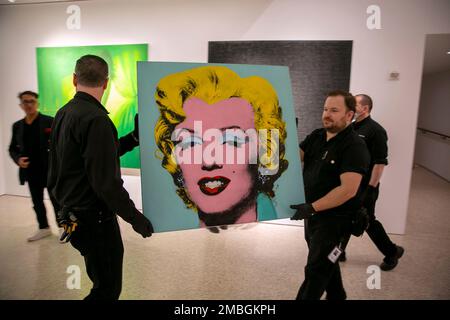 The 1964 painting Shot Sage Blue Marilyn by Andy Warhol is carried in Christie's showroom in New York City on Sunday, May 8, 2022. The auction house predicts it will sell for $200 million on Monday, becoming the most expensive 20th-century artwork to sell at auction. (AP Photo/Ted Shaffrey)