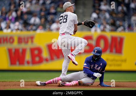 Texas Rangers right fielder Adolis Garcia (53) and left fielder Ezequiel  Duran (20) celebrate after closing the tenth inning of a baseball game  against the New York Yankees, Friday, June 23, 2023