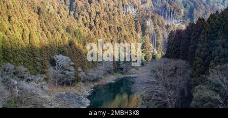 A view of the Oi River valley west of Kyoto from a JR West train on the Sanin (or Sagano) Line. Stock Photo