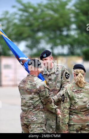 Today, 2-2 Assault Helicopter Battalion, 2nd Combat Aviation Brigade, conducted a change of command. Col. Aaron Martin hands off the battalion colors to Lt. Col. Scott Gale, the incoming commander. Stock Photo