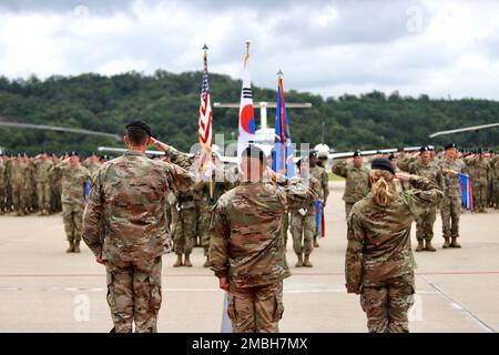 Today, 2-2 Assault Helicopter Battalion, 2nd Combat Aviation Brigade, conducted a change of command. Col. Aaron Martin is accompanied by Lt. Col Bridget Dalziel, the outgoing commander and Lt. Col. Scott Gale, the incoming commander, saluting the formation prior to inspecting them. Stock Photo