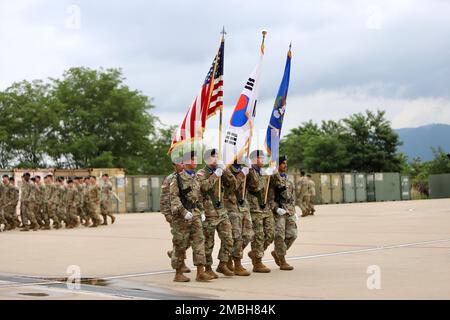 Today, 2-2 Assault Helicopter Battalion, 2nd Combat Aviation Brigade, conducted a change of command. Soldiers march with the U.S., Korean flags and the battalion colors during the pass and review. Stock Photo