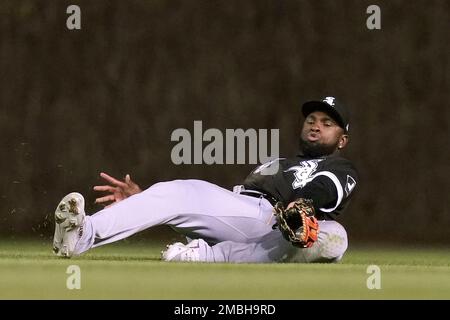 Chicago White Sox's Luis Robert passes third base coach Joe