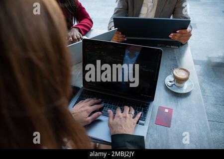 Close-up of a female programmer typing a code on her laptop before taking a break to shop online Stock Photo