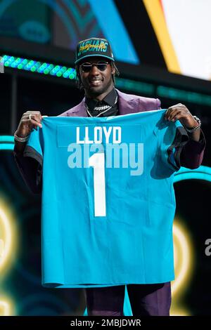 Utah linebacker Devin Lloyd holds a team jersey after he was