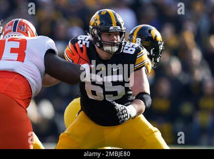 FILE - Iowa offensive lineman Tyler Linderbaum (65) looks to make a block  during the first half of an NCAA college football game against Indiana in  Iowa City, Iowa, Saturday, Sept. 4