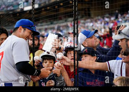 Chicago Cubs' Seiya Suzuki, of Japan, adjusts his hat as he pauses in the  dugout prior to a baseball game against the Arizona Diamondbacks Sunday,  May 15, 2022, in Phoenix. (AP Photo/Ross