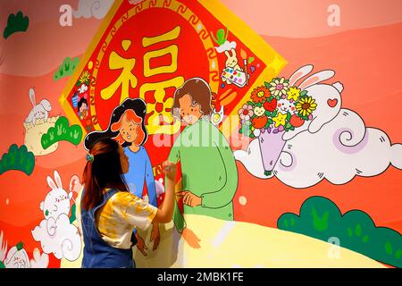 Artist Helen So works on a Lunar New Year painting at the Essex Market in New York City, January 20, 2023. The painting features ...(see more details) Stock Photo