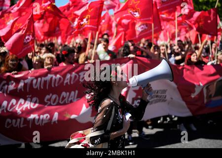 Members of the Portuguese Communist Party Youth carry flags and