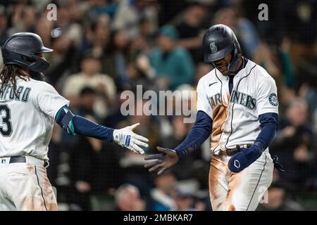 Seattle Mariners' Mitch Haniger wearing the home run helmet in the dugout  after hitting a solo home run against the Detroit Tigers during a baseball  game, Wednesday, Oct. 5, 2022, in Seattle. (
