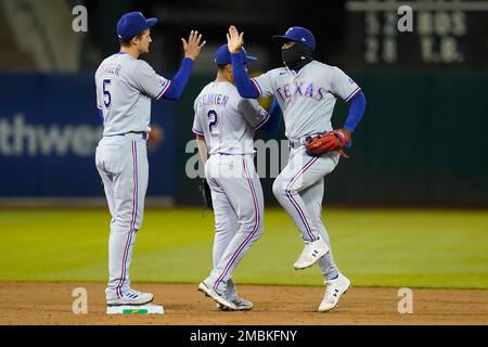 Texas Rangers' Corey Seager, Ezequiel Duran, Marcus Semien, Nathaniel Lowe  and Adolis Garcia, from left, celebrate the team's 4-2 win in a baseball  game against the Philadelphia Phillies, Wednesday, June 22, 2022