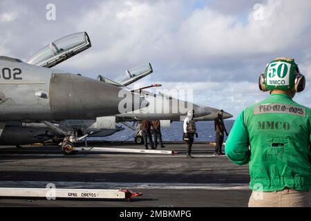 PHILIPPINE SEA (June 17, 2022) Sailors prepare for flight operations on the flight deck of the U.S. Navy’s only forward-deployed aircraft carrier USS Ronald Reagan (CVN 76) during Valiant Shield 2022 (VS22).  VS22 is a U.S.-only, biennial field training exercise (FTX) focused on integration of joint training in a multi-domain environment. This training builds real-world proficiency in sustaining joint forces through detecting, locating, tracking, and engaging units at sea, in the air, on land, and in cyberspace in response to a range of mission areas. Stock Photo