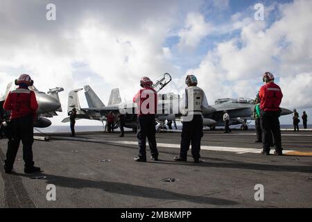 PHILIPPINE SEA (June 17, 2022) Sailors prepare for flight operations on the flight deck of the U.S. Navy’s only forward-deployed aircraft carrier USS Ronald Reagan (CVN 76) during Valiant Shield 2022 (VS22).  VS22 is a U.S.-only, biennial field training exercise (FTX) focused on integration of joint training in a multi-domain environment. This training builds real-world proficiency in sustaining joint forces through detecting, locating, tracking, and engaging units at sea, in the air, on land, and in cyberspace in response to a range of mission areas. Stock Photo