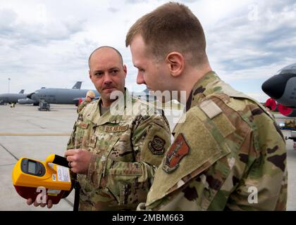 U.S. Air Force Tech. Sgt. Derek Johnson, 92nd Operational Medical Readiness Squadron bioenvironmental engineer, instructs Airman 1st Class Stephen Evans, 141st Medical Group Detachment 1 medical technician, on how to use radiological detecting equipment at Fairchild Air Force Base, Washington, June 16, 2022. The 92nd Medical Group Bioenvironmental flight held an exercise training Airmen on the handling and detection of radioactively contaminated assets. Stock Photo