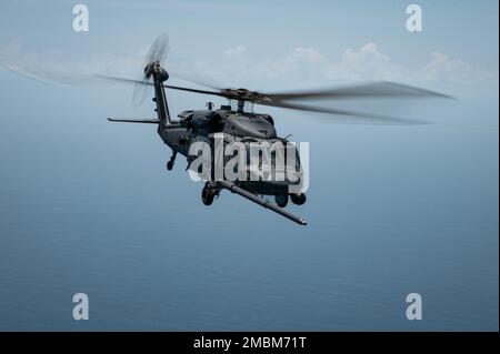 A HH-60G Pave Hawk Helicopter flys off the coast of Florida on June 16, 2022 during a Turkey Shoot Competition. During the competition aircrew members competed on skills such as aircraft weapons employment, helicopter air to air refueling, degraded navigation, degraded search, and confined hoisting. Stock Photo