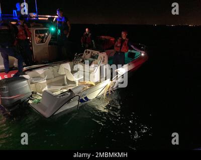 Coast Guard Station Miami Beach small boat crew inspecting a boat that was part of a collision near Key Biscayne, Florida, June 17, 2022. Coast Guard, Miami-Dade Fire Rescue, Miami-Dade Police Department, and Florida Fish and Wildlife crews assisted 10 people and recovered two bodies after their vessels collided. Stock Photo