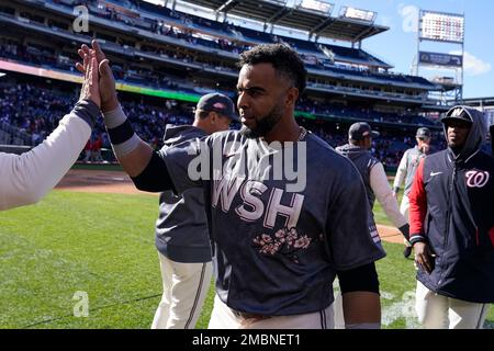 Washington Nationals' Nelson Cruz, left, walks past Texas Rangers starting  pitcher Dane Dunning, right, on his way to the dugout after being thrown  out at home while trying to score on a