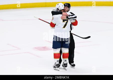 Linesman Vaughan Rody (73) hugs Florida Panthers right wing Claude Giroux  (28) after Panthers defeated the