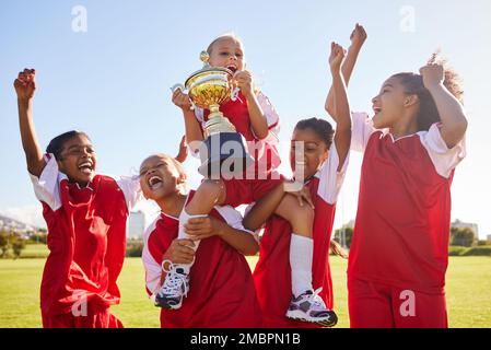 Soccer, team and trophy with children in celebration together as a girl winner group for a sports competition. Football, teamwork and award with Stock Photo